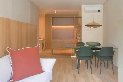 a living room with a table and green chairs at Dixo's Oporto Apartments Duplex in Porto