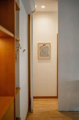 a hallway with a white wall with a picture on it at Dixo's Oporto Apartments Duplex in Porto