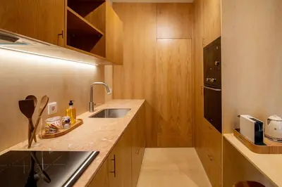 a small kitchen with a sink and a microwave at Dixo's Oporto Apartments Duplex in Porto