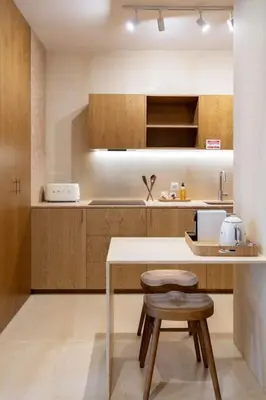 a kitchen with a table and two stools at Dixo's Oporto Apartments Duplex in Porto