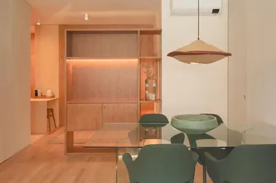 a dining room with a glass table and green chairs at Dixo's Oporto Apartments Duplex in Porto