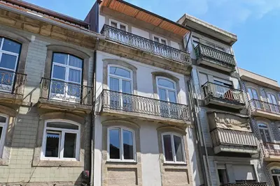 a building with balconies on the side of it at Almada e Fado in Porto