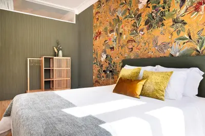 a bedroom with a large bed with a colorful wall at Cardosas Block Luxury Apartment in Porto
