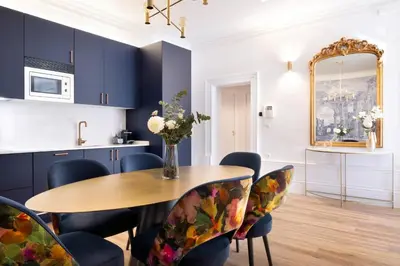 a dining room with a table and chairs and a mirror at Cardosas Block Luxury Apartment in Porto