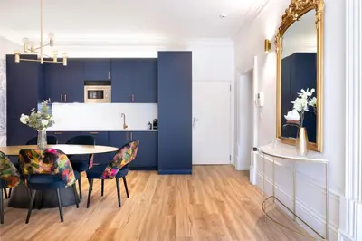 a kitchen and dining room with a table and chairs at Cardosas Block Luxury Apartment in Porto