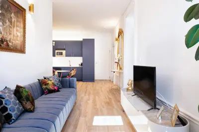 a living room with a blue couch and a fireplace at Cardosas Block Luxury Apartment in Porto