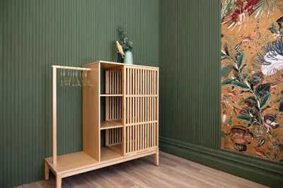 a wooden book shelf in a room with a painting at Cardosas Block Luxury Apartment in Porto