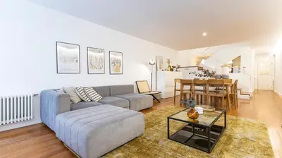 a living room with a couch and a table at Fábrica Three-Story Charm by LovelyStay in Porto