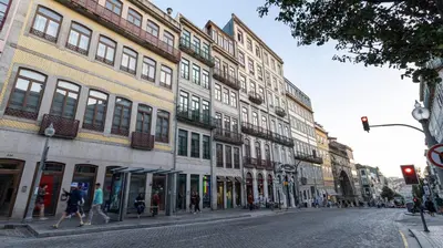 a city street with buildings and people walking down the street at Mouzinho's Place by LovelyStay in Porto