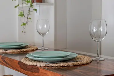 a table with two plates and two wine glasses at Apartment in city center in Porto