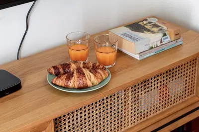 a table with a plate of food and two glasses of orange juice at Apartment in city center in Porto