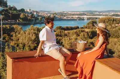a man and a woman sitting on a bench at The Lost Garden in Vila Nova de Gaia