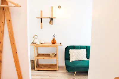 a living room with a green chair and a table at The Lost Garden in Vila Nova de Gaia