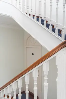 a staircase with white railings and a white door at Oporto View Apartments in Porto