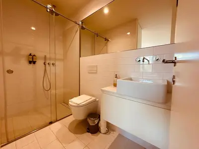 a bathroom with a shower and a toilet and a sink at Bombarda H in Porto