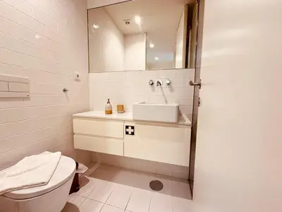 a bathroom with a toilet and a sink and a mirror at Bombarda H in Porto