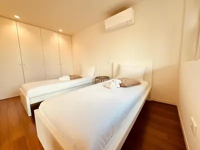 two beds in a room with white walls at Bombarda H in Porto