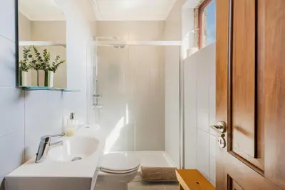 a bathroom with a sink and a toilet and a shower at Hey Apartments B in Porto