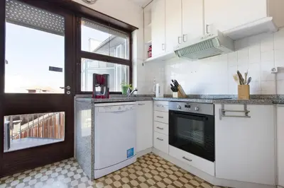 a kitchen with white appliances and a window at LV Premier Apartments Clerigos- RE1 in Porto