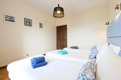 two beds in a room with two blue towels at LV Premier Apartments Clerigos- RE1 in Porto
