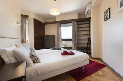 a bedroom with a large white bed and a window at LV Premier Apartments Clerigos- RE1 in Porto