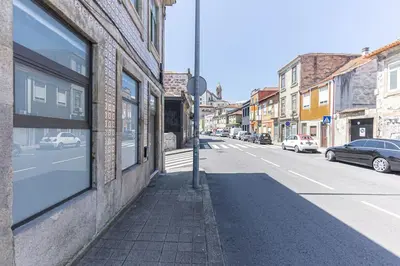 an empty city street with cars parked on the side of a building at Dream Bonfim in Porto