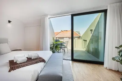 a bedroom with a bed and a large glass window at GuestReady - Porto's Modern Comfort in Porto