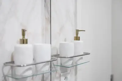 a bathroom with three rolls of toilet paper on a shelf at GuestReady - Porto's Modern Comfort in Porto