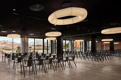 a room with chairs and tables and chandeliers at Tivoli Kopke Porto Gaia Hotel in Vila Nova de Gaia