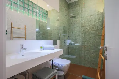 a bathroom with a sink and a toilet and a shower at ApartmentsPorto - Apartamento Belas Artes in Porto