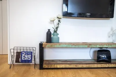 a living room with a tv on a wall at ApartmentsPorto - Apartamento Belas Artes in Porto