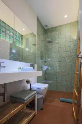 a bathroom with a toilet and a glass shower at ApartmentsPorto - Apartamento Belas Artes in Porto