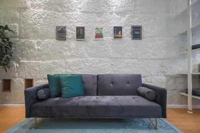a couch in a living room with a wall with pictures at ApartmentsPorto - Apartamento Belas Artes in Porto