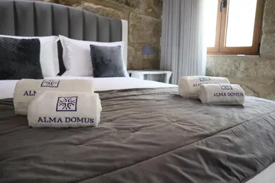 a large bed with two pillows on top of it at Boavista Rustic House in Porto