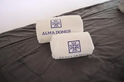 two towels are sitting on top of a blanket at Boavista Rustic House in Porto