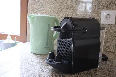 a coffee maker sitting on a counter next to a cup at Boavista Rustic House in Porto