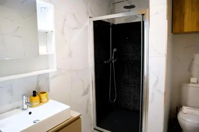 a bathroom with a shower with a black shower at Francos Family House in Porto