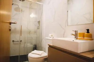 a bathroom with a toilet and a sink and a shower at Francos Family House in Porto