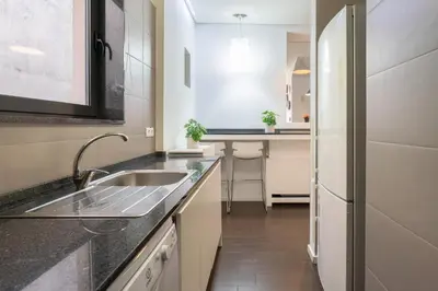 a kitchen with a sink and a counter at Host Wise - Cozy House w Balcony in Porto