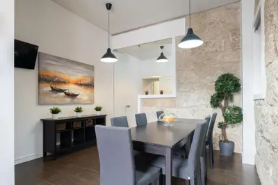 a dining room with a table and chairs at Host Wise - Cozy House w Balcony in Porto