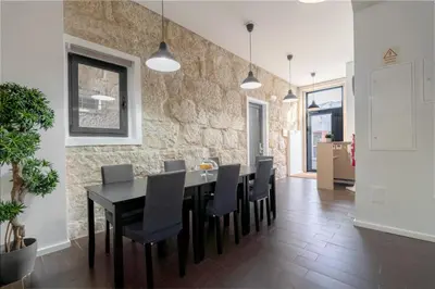 a dining room with a black table and black chairs at Host Wise - Cozy House w Balcony in Porto