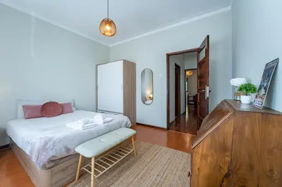 a bedroom with a large bed and a window at Patio House - 2 Bedroom flat - Pet Friendly in Porto