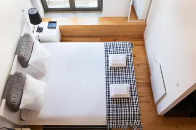a bedroom with a bed with a blanket on the floor at Almada Apartments 468 in Porto