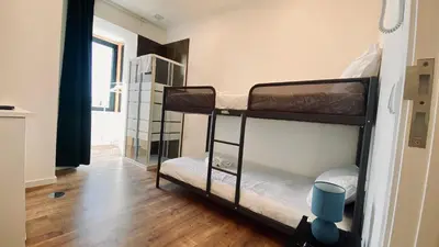a bedroom with a white bed with two towels on it at Raul Dória - Guesthouse in Porto