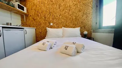 a bedroom with a bed with two towels on it at Raul Dória - Guesthouse in Porto