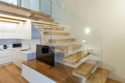 a kitchen with a glass wall with a staircase at ApartmentsPorto - Almada 318 in Porto