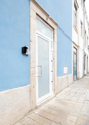 a door on the side of a blue building at Aparts d'Avó in Porto