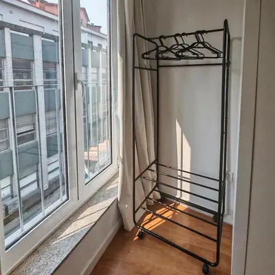 a iron bed in a room next to a window at Aparts d'Avó in Porto