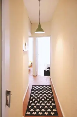 a hallway with a black and white rug on the floor at Lulapartment in Porto
