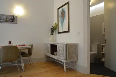 a dining room with a table and a table and a fireplace at Oporto Almada 329 in Porto